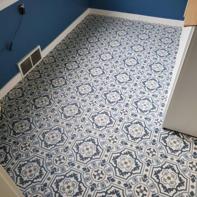 Lansing home kitchen with a decorative blue-patterned tile floor and blue wall